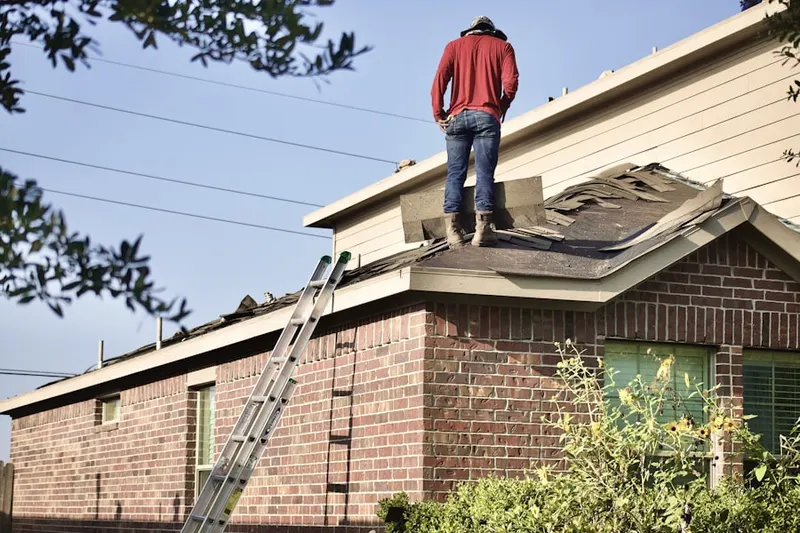 Professional roofer working on a residential roof in Village of Church Creek